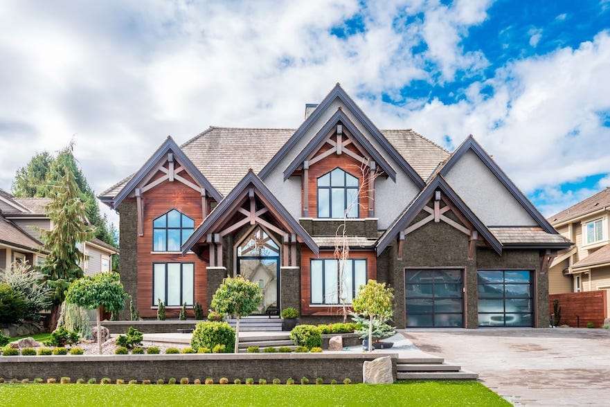 suburban home during the daytime with evolve stone installed on garage and accents of house